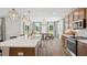 Bright kitchen features an island with quartz countertops, pendant lights, and stainless steel appliances at 406 Cadbury Loop, Summerville, SC 29486