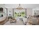 Bright living room with a stylish chandelier, modern furniture, and sliding glass doors overlooking a lush lawn at 406 Cadbury Loop, Summerville, SC 29486
