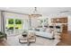 Open living space with sliding glass doors to the patio, kitchen view, and modern chandelier at 406 Cadbury Loop, Summerville, SC 29486