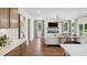 Open-concept living room with an electric fireplace and seamless kitchen view at 406 Cadbury Loop, Summerville, SC 29486