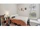 Comfortable bedroom with wood floors, ample light, and organized bookshelf at 45 Sycamore Ave # 811, Charleston, SC 29407