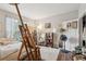 Bright bedroom featuring a comfortable bed, wood floors, and an easel with artwork at 45 Sycamore Ave # 811, Charleston, SC 29407