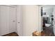 Hallway with storage closet leading to a room filled with natural light and hardwood floors at 45 Sycamore Ave # 811, Charleston, SC 29407