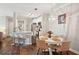 Open-concept kitchen and dining area featuring a breakfast bar and modern chandelier at 45 Sycamore Ave # 811, Charleston, SC 29407