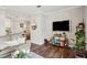 Open living area with a cozy seating area, hardwood floors, and a view into the dining space at 45 Sycamore Ave # 811, Charleston, SC 29407