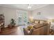 Bright living room featuring a comfortable leather sofa and french doors leading to outdoor balcony at 45 Sycamore Ave # 811, Charleston, SC 29407