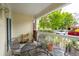Cozy porch featuring a metal table with four chairs and views of the green landscaped surroundings at 45 Sycamore Ave # 811, Charleston, SC 29407