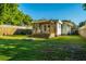 Spacious backyard featuring a well-maintained lawn, wooden fence, and pergola-covered patio with furniture at 4515 Holmes Ave, North Charleston, SC 29405