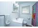 Clean bathroom with white vanity, mirror, and a colorful shower curtain at 4515 Holmes Ave, North Charleston, SC 29405