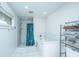 Clean bathroom featuring a tub with shower, white tile surround, and a storage rack at 4515 Holmes Ave, North Charleston, SC 29405