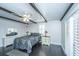 Stylish bedroom with dark wood floors, ceiling beams, and elegant furniture at 4515 Holmes Ave, North Charleston, SC 29405