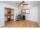 Bright bedroom with hardwood floors, a ceiling fan, and a closet with built-in shelving at 4515 Holmes Ave, North Charleston, SC 29405