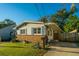 Quaint home with a brick foundation, charming blue shutters, and well-maintained landscaping at 4515 Holmes Ave, North Charleston, SC 29405