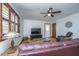 Comfortable living room featuring hardwood floors, a ceiling fan, and a large leather sofa at 4515 Holmes Ave, North Charleston, SC 29405