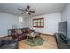 Inviting living room with wood floors, ceiling fan, and comfortable leather furniture at 4515 Holmes Ave, North Charleston, SC 29405
