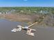 Beautiful aerial view showing a long wooden dock on the intercoastal waterway with multiple boats docked at 4637 Bonnie Marie Way, North Charleston, SC 29405
