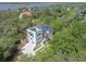 Gorgeous aerial view of the home nestled among lush greenery with a glimpse of the nearby waterway at 4637 Bonnie Marie Way, North Charleston, SC 29405