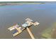 An aerial of a private boat dock on the water showing boat slips and a seating area on the pier at 4637 Bonnie Marie Way, North Charleston, SC 29405