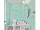 A charming, nicely lit bathroom with a corner sink, new toilet, decorative mirror and fresh, clean walls at 4637 Bonnie Marie Way, North Charleston, SC 29405