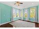 Bright bedroom with hardwood floors, a ceiling fan, large windows, and white curtains at 4637 Bonnie Marie Way, North Charleston, SC 29405