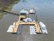 Aerial view of a private boat dock featuring multiple boat slips and a charming covered seating area at 4637 Bonnie Marie Way, North Charleston, SC 29405