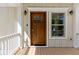 Inviting home entrance with a wood door, stylish sconces, and a window providing natural light at 4637 Bonnie Marie Way, North Charleston, SC 29405