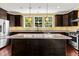 Modern kitchen with stainless steel appliances, a kitchen island, granite countertops, and lots of windows at 4637 Bonnie Marie Way, North Charleston, SC 29405
