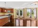 Bright kitchen with hardwood floors, wooden cabinetry, and ample natural light from multiple windows at 4637 Bonnie Marie Way, North Charleston, SC 29405