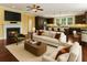 Open-concept living area with fireplace, hardwood floors, and seamless flow into a modern kitchen with an island at 4637 Bonnie Marie Way, North Charleston, SC 29405