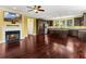 Open-concept living room and kitchen featuring a fireplace, TV, hardwood floors, and stainless steel appliances at 4637 Bonnie Marie Way, North Charleston, SC 29405