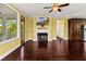 Cozy living room with fireplace, hardwood floors, a large window, and an adjacent sunroom for relaxing at 4637 Bonnie Marie Way, North Charleston, SC 29405