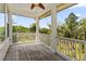 Charming outdoor porch with wood floors and white railings providing beautiful views of surrounding trees at 4637 Bonnie Marie Way, North Charleston, SC 29405