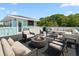 Luxurious rooftop deck with comfortable seating, a built-in bar, and a cozy fire pit at 4637 Bonnie Marie Way, North Charleston, SC 29405