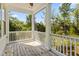 Inviting screened porch offers a relaxing space with wood floors and a view of the surrounding lush greenery at 4637 Bonnie Marie Way, North Charleston, SC 29405