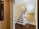 Staircase with hardwood steps and white risers, showcasing a classic design, elevator access nearby at 4637 Bonnie Marie Way, North Charleston, SC 29405