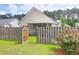 Features include fenced yard with flower bush, lush lawn, and screened porch at 4856 Carnoustie Ct, Summerville, SC 29485