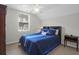 Relaxing bedroom features a bed with blue accents, paired with window view and classic wood furnishings at 4856 Carnoustie Ct, Summerville, SC 29485