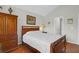 Cozy bedroom features a well-lit space with hardwood floors and traditional style wooden furniture at 4856 Carnoustie Ct, Summerville, SC 29485