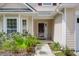 A close-up of a charming front door and the meticulously manicured yard at 4856 Carnoustie Ct, Summerville, SC 29485