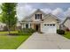 Charming two-story home with a well-maintained lawn and a white garage door at 4856 Carnoustie Ct, Summerville, SC 29485
