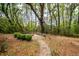 Wooded backyard features walking path and custom fire pit area at 4991 Sound View Dr, Mount Pleasant, SC 29466