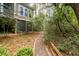Backyard walking path lined by landscaped foliage leading to the residence at 4991 Sound View Dr, Mount Pleasant, SC 29466