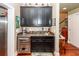 Elegant bar area with dark cabinetry, granite countertops, and wine cooler at 4991 Sound View Dr, Mount Pleasant, SC 29466
