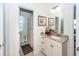 Bright bathroom featuring granite countertop vanity with open doorway leading to the commode at 4991 Sound View Dr, Mount Pleasant, SC 29466