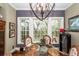 Dining area with round glass table, wicker chairs, and view of a natural backyard at 4991 Sound View Dr, Mount Pleasant, SC 29466