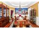 Formal dining room with hardwood floors, statement chandelier, and decorative wall mural with room to seat eight at 4991 Sound View Dr, Mount Pleasant, SC 29466