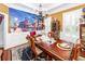 Elegant dining room featuring hardwood floors, statement chandelier, and decorative wall mural at 4991 Sound View Dr, Mount Pleasant, SC 29466