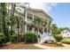 Charming two-story home with a grand front porch framed by lush palm trees at 4991 Sound View Dr, Mount Pleasant, SC 29466