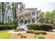 Stately two-story home features large front porch and well-manicured landscaping at 4991 Sound View Dr, Mount Pleasant, SC 29466