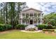 Beautiful two-story home features a grand front porch and mature palm trees at 4991 Sound View Dr, Mount Pleasant, SC 29466